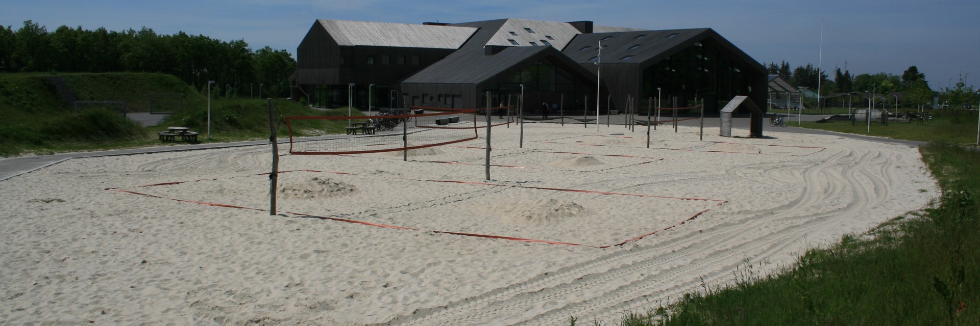 Beachvolley net sat op i et stort sandareal ved siden af Hjertet